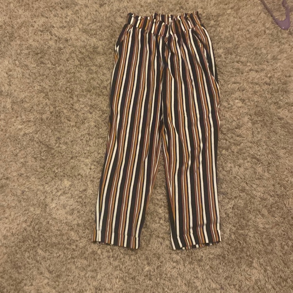 This is a formal black, white, and pink dress pants in size small.